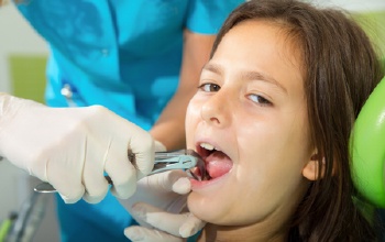 Child having tooth extracted