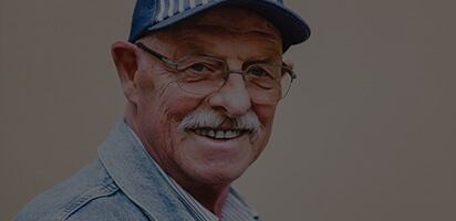 Senior man with mustache smiling
